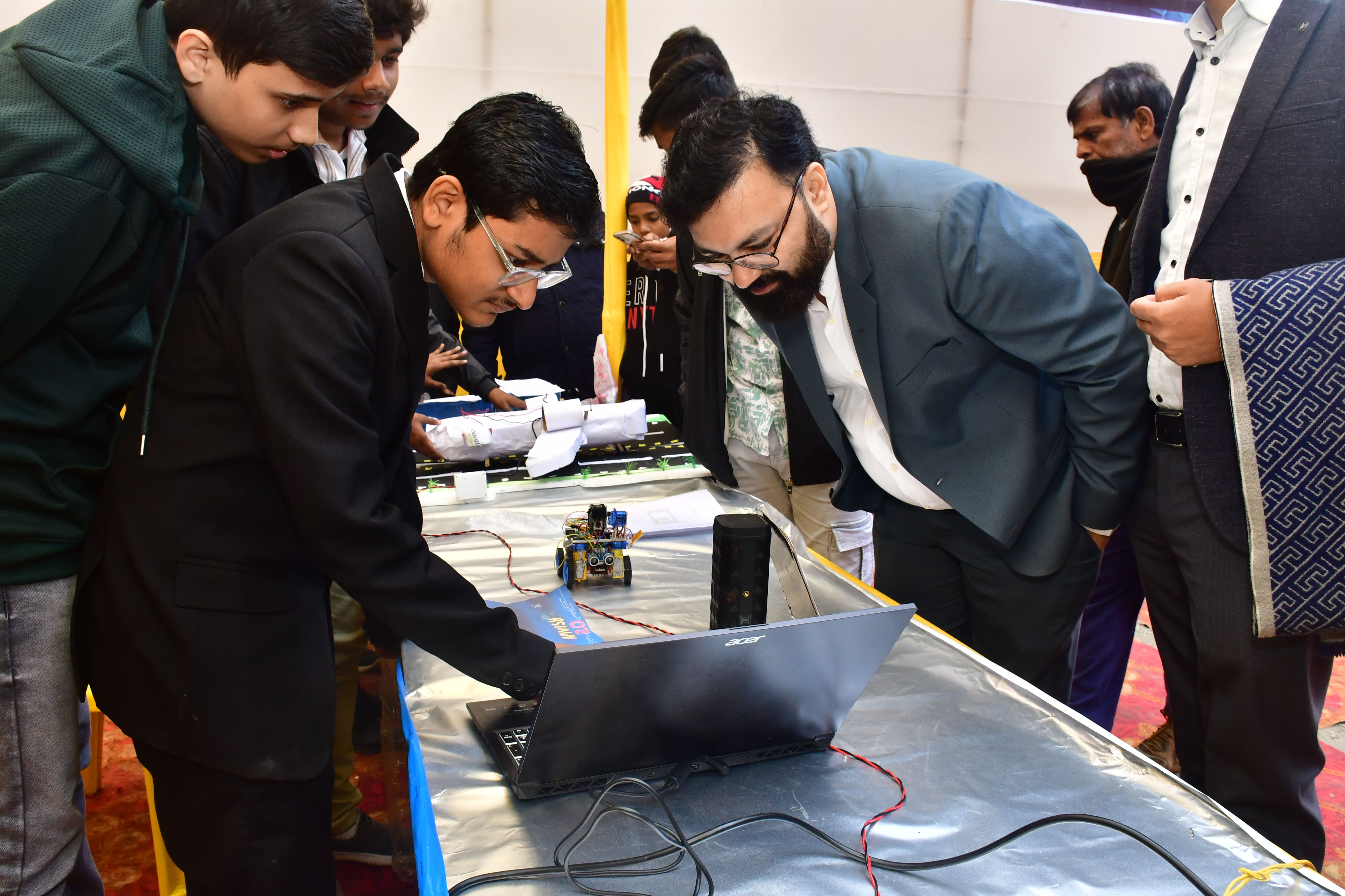 Robotics prototype demonstration with audience observing at exhibition